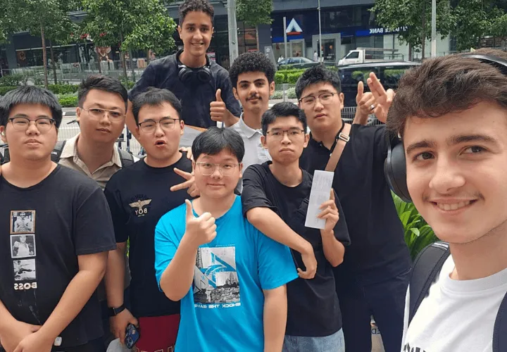 Multicultural group of smiling ELS students outdoors