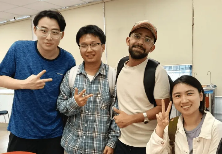 Multicultural group of four smiling students in ELS classroom